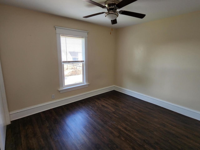 unfurnished room featuring baseboards, dark wood-type flooring, and a ceiling fan