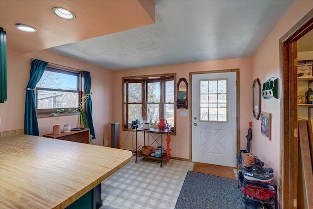 foyer entrance featuring recessed lighting, light floors, and baseboards