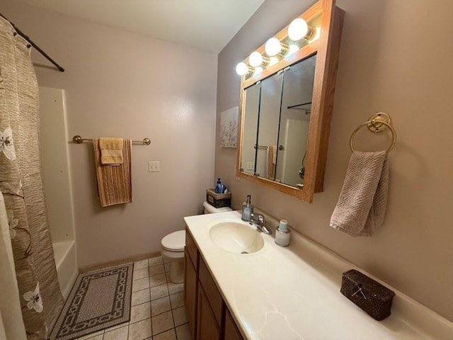 bathroom with tile patterned flooring, baseboards, toilet, shower / tub combo, and vanity