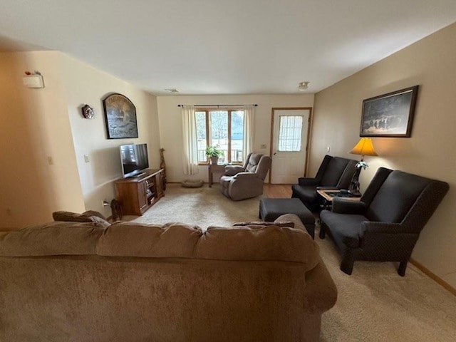 carpeted living room featuring baseboards