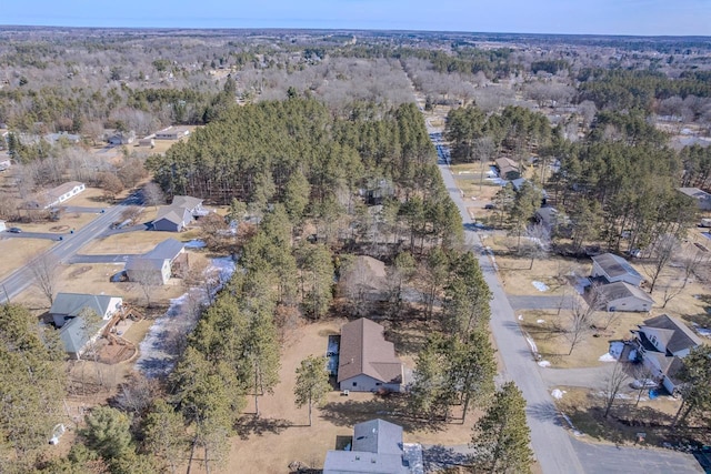 birds eye view of property with a wooded view