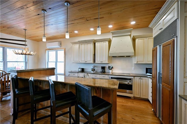 kitchen with premium range hood, light wood finished floors, stainless steel appliances, an AC wall unit, and wood ceiling