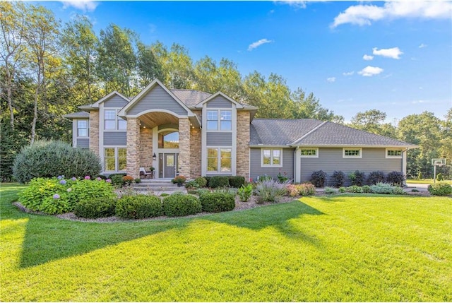 view of front of property featuring a front lawn and stone siding