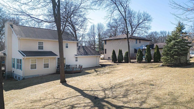 view of side of property with a wooden deck and a chimney