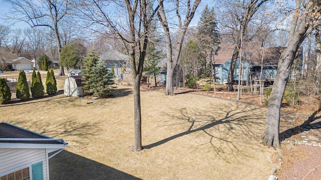 view of yard with an outbuilding and a shed