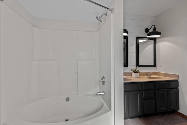 full bathroom with shower / bathing tub combination, double vanity, and a sink