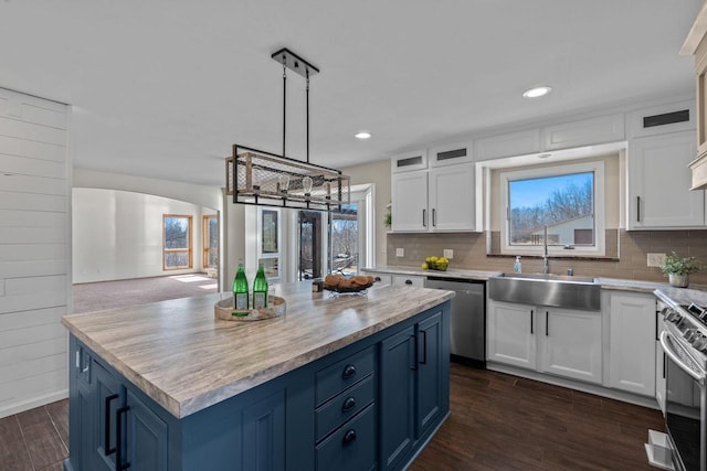 kitchen featuring a sink, white cabinets, blue cabinets, and stainless steel appliances