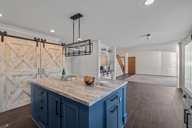 kitchen featuring blue cabinets, dark wood finished floors, a center island, recessed lighting, and a barn door