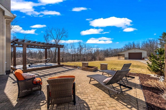 view of patio / terrace with a garage, an outdoor structure, and a pergola