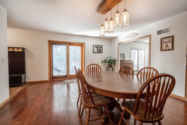 dining area with hardwood / wood-style floors, baseboards, and visible vents