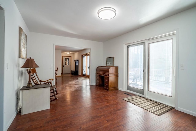 interior space featuring baseboards and wood finished floors