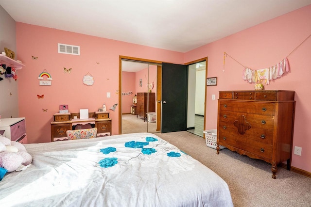 bedroom featuring light carpet, visible vents, and a closet