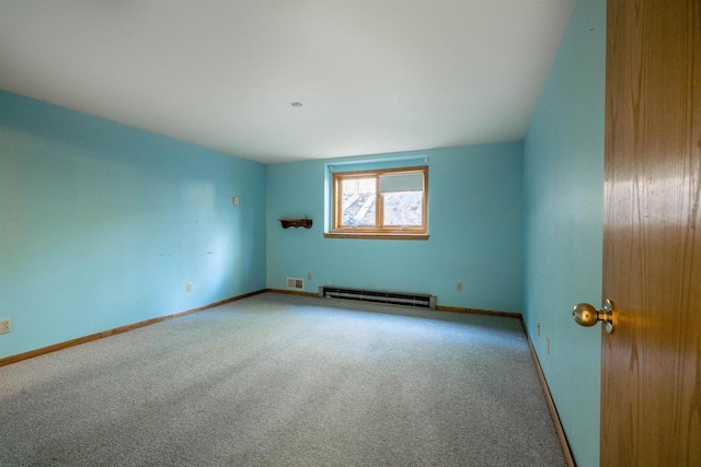 carpeted empty room featuring baseboards and baseboard heating