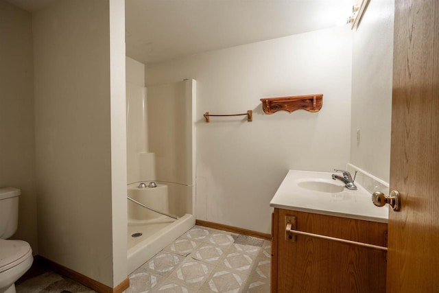 bathroom with tile patterned floors, toilet, a shower stall, baseboards, and vanity