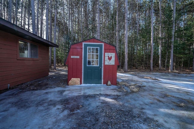 view of shed featuring a wooded view