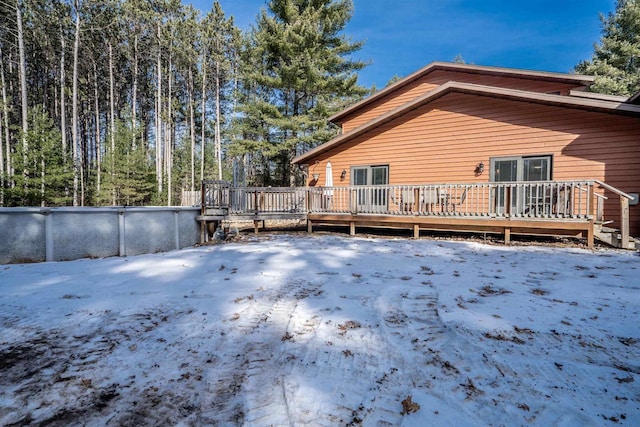 snow covered property featuring a deck