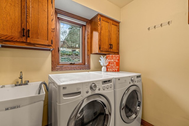 laundry room featuring a sink, cabinet space, and independent washer and dryer