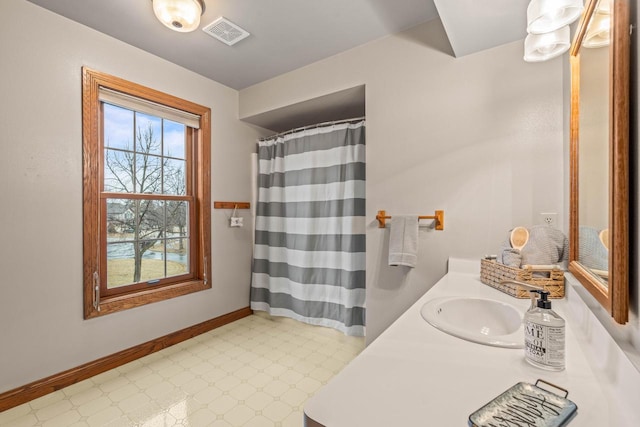 bathroom with tile patterned floors, visible vents, vanity, and baseboards