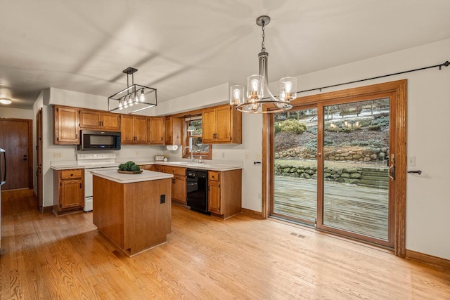 kitchen with light wood finished floors, a sink, black appliances, light countertops, and brown cabinets