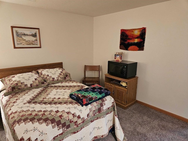 carpeted bedroom featuring baseboards