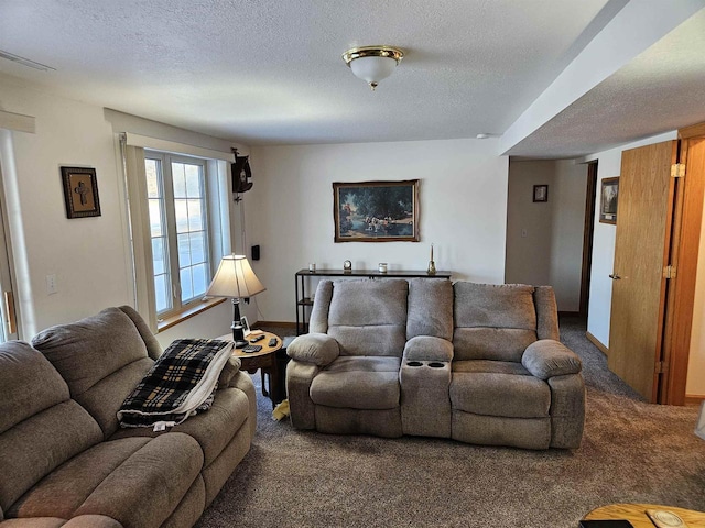 carpeted living room featuring visible vents, a textured ceiling, and baseboards