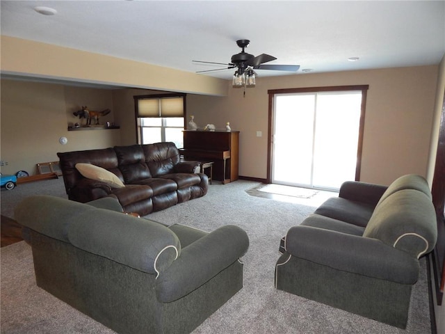 carpeted living room with a healthy amount of sunlight and baseboards