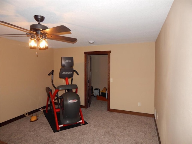 workout room featuring carpet flooring, a ceiling fan, and baseboards