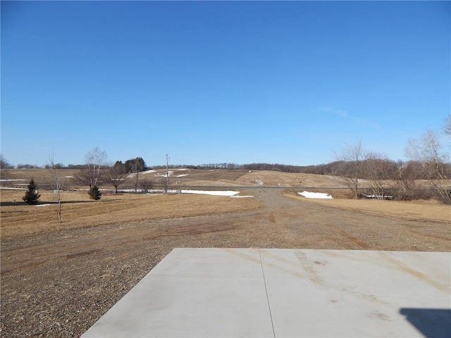 view of yard with a rural view