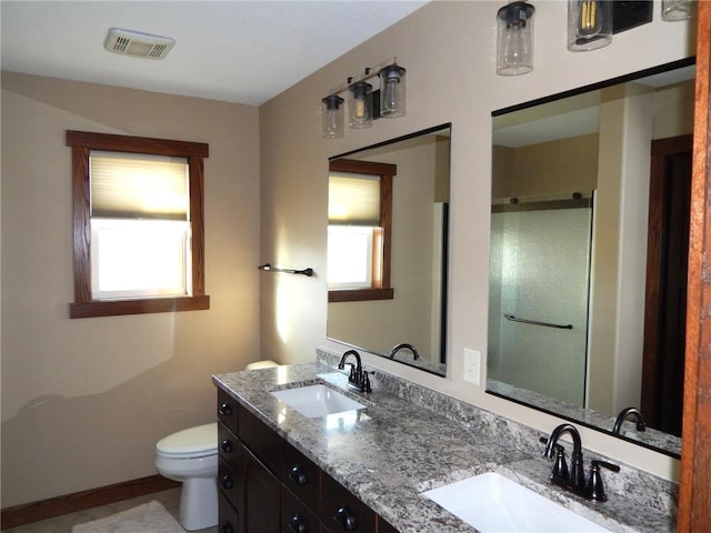 full bath featuring a shower stall, toilet, visible vents, and a sink