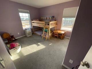 bedroom featuring baseboards and carpet flooring