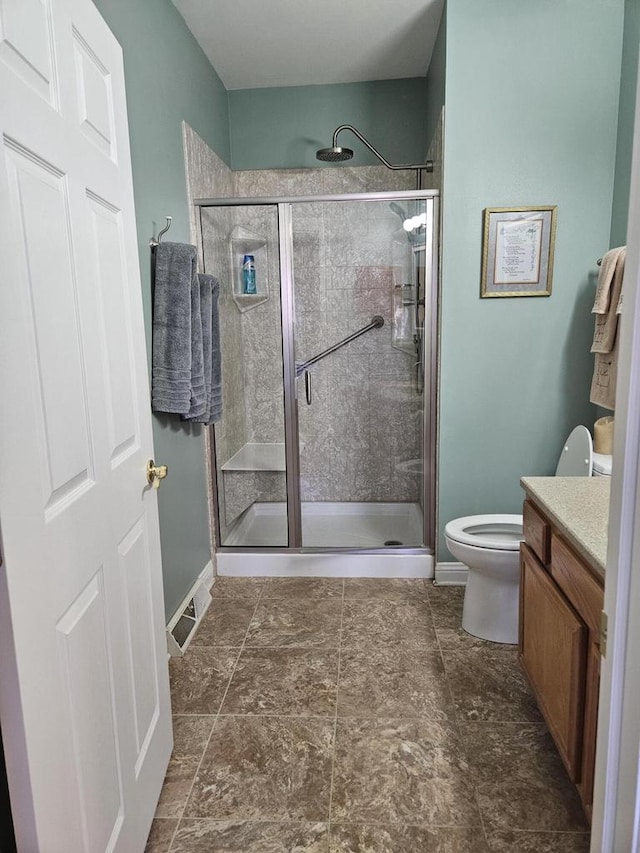 full bath with baseboards, toilet, a stall shower, and vanity