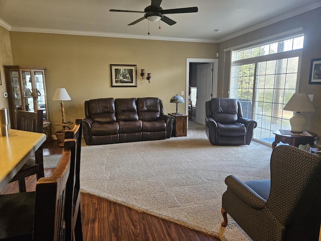 carpeted living room featuring crown molding and ceiling fan