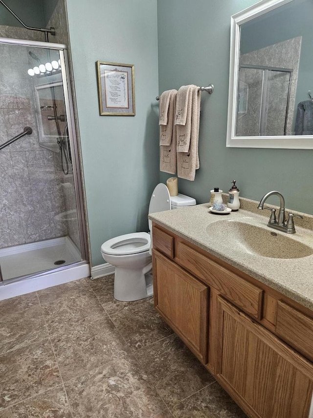 full bathroom with a shower stall, toilet, and vanity