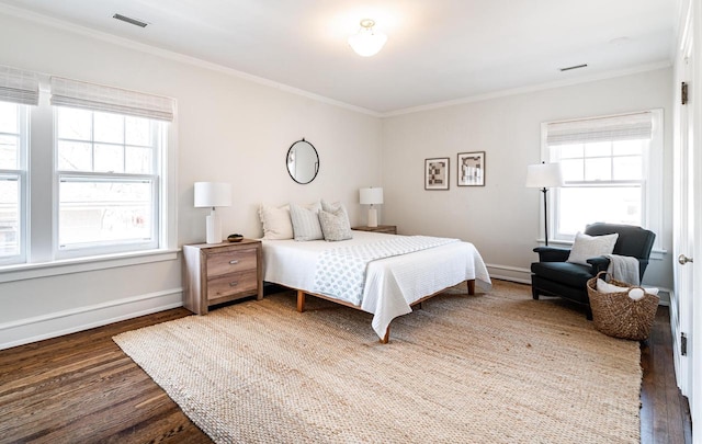 bedroom featuring multiple windows, wood finished floors, and ornamental molding