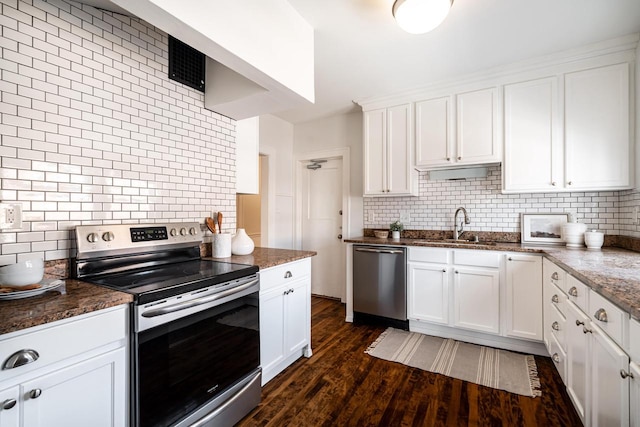 kitchen with backsplash, dark wood-type flooring, white cabinets, stainless steel appliances, and a sink