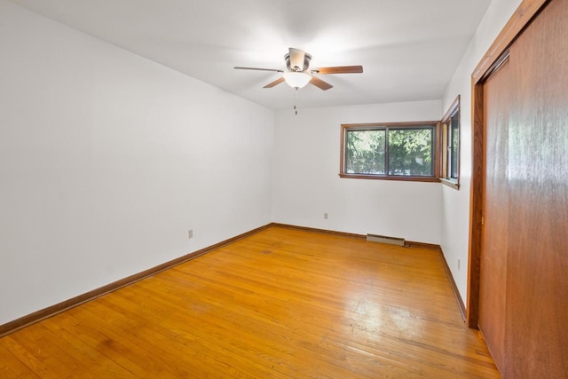 unfurnished bedroom featuring light wood-style floors, a closet, and baseboards