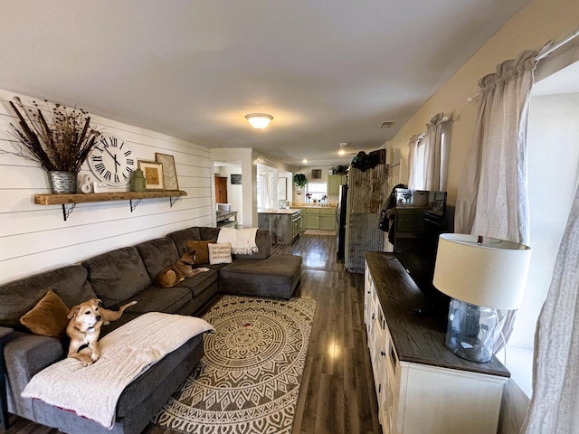 living room featuring visible vents and dark wood-type flooring