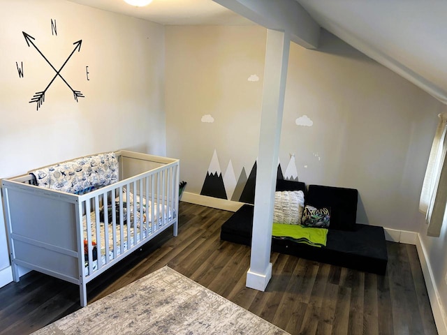 bedroom featuring vaulted ceiling, wood finished floors, and baseboards