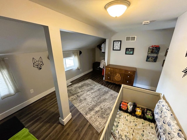 bedroom featuring visible vents, baseboards, and wood finished floors