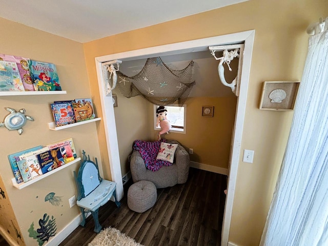 living area with wood finished floors and baseboards