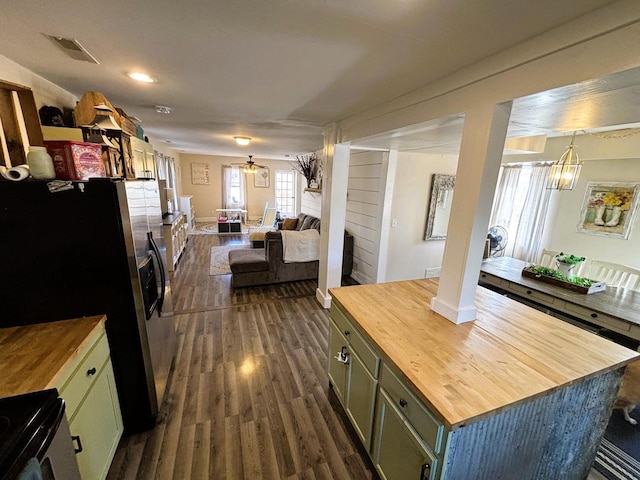 kitchen featuring visible vents, dark wood finished floors, stainless steel refrigerator with ice dispenser, wood counters, and open floor plan