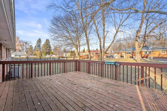 wooden terrace with a fenced backyard and a residential view