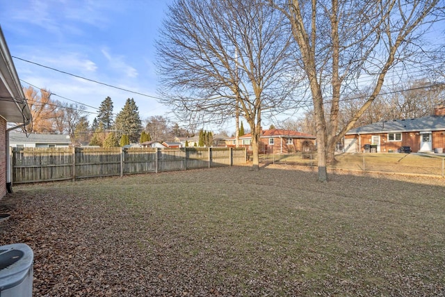 view of yard with a fenced backyard and a residential view