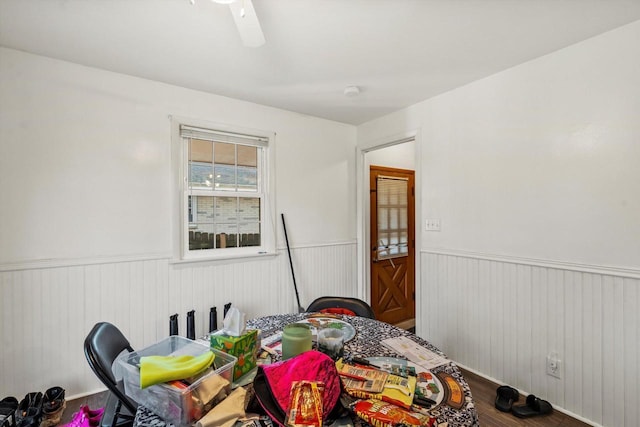 bedroom with wainscoting, a ceiling fan, and wood finished floors