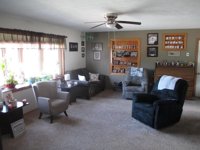 living room with a ceiling fan and carpet