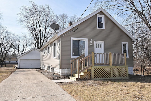 bungalow-style home featuring a detached garage and an outdoor structure