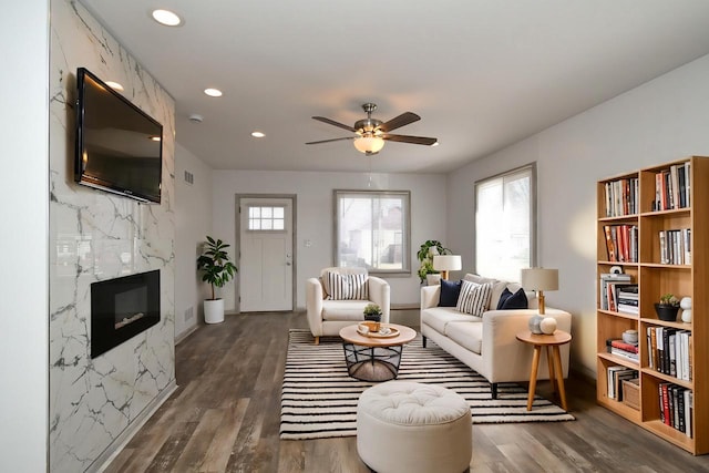 living room featuring ceiling fan, recessed lighting, wood finished floors, and a premium fireplace