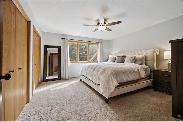 bedroom with a ceiling fan and carpet