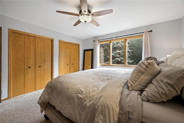 bedroom with multiple closets and ceiling fan