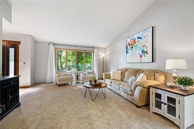 living room featuring lofted ceiling, baseboards, and light carpet